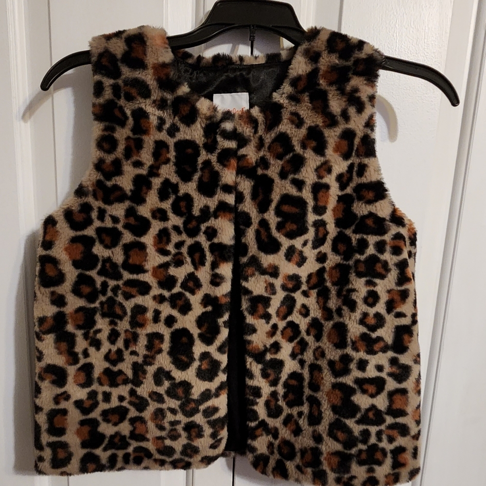 Leopard print fuzzy vest with one fastener at the top.